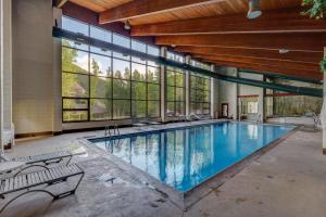 a large swimming pool in a building with windows at Pines #2124 in Keystone