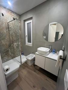 a bathroom with a sink toilet and a mirror at El Nido Suite in Tornavento