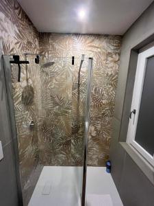 a shower in a bathroom with a wall at El Nido Suite in Tornavento