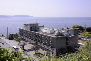 a building next to a body of water at Kamakura Park Hotel in Kamakura