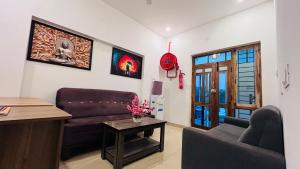 a living room with a couch and a table at THE CHALET- Pondicherry, Near Eden Beach - BMC in Pondicherry