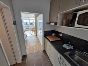 a kitchen with a sink and a counter top at Die lütte Kajüte Südstrand in Fehmarn