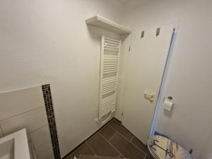 a bathroom with a toilet and a window at Die lütte Kajüte Südstrand in Fehmarn