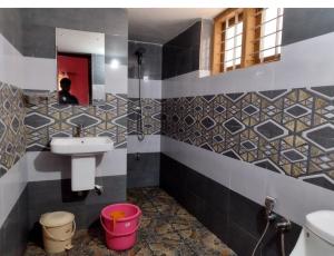 a bathroom with a sink and a mirror at Golden cypress resort with pool in Vythiri +10 photos
