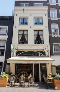 a building with chairs and tables in front of a building at Hotel Central Staytion in Amsterdam
