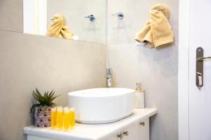 a bathroom with a sink and a mirror at Casa Mary Aegina in Egina +19 photos