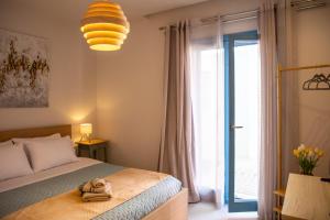 a bedroom with a bed and a large glass door at Casa Mary Aegina in Egina