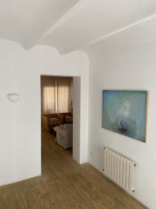 a white living room with a painting on the wall at Puerto de Cala Ratjada in Cala Ratjada