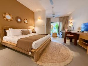 a bedroom with a large bed and a desk at Be Cosy by LOV Mauritius in Trou aux Biches +76 photos