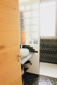 a bathroom with a sink on a counter and a window at L'Oustalet Arles in Arles +16 photos