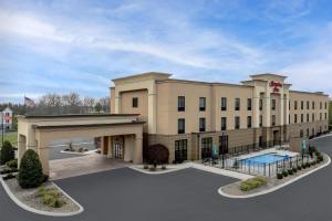 a large building with a pool in front of it at Hampton Inn Crossville in Crossville