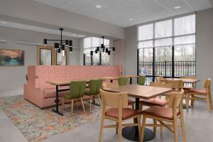 a waiting room with tables and chairs and a couch at Hampton Inn Crossville in Crossville
