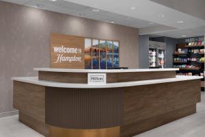 a welcome sign at a welcome counter in a store at Hampton Inn Crossville in Crossville