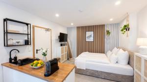 a hotel room with a bed and a table with fruit on it at City Apartments in Rostock