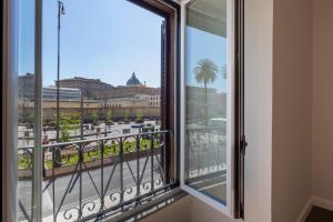a balcony with a view of a city at San Pietro Grand Suite in Rome