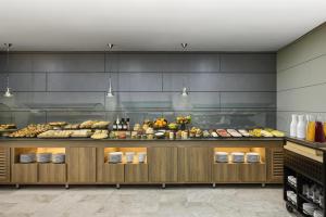 ein Buffet mit vielen verschiedenen Speisen in der Unterkunft iStay by NH Zaragoza Sport Hotel in Saragossa