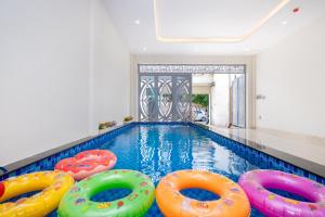 a swimming pool with colorful inflatables in a house at Villa 5 Lạc Long Quân - Bãi Sau in Vung Tau