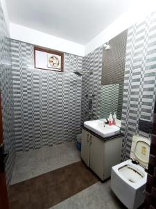 a bathroom with a sink and a toilet at Hotel Vivara in Lucknow