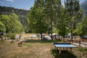 a ping pong table in the middle of a field at Huttopia Val Cenis in Val Cenis