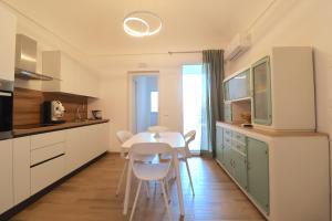 a kitchen with a table and chairs in a room at Mastru Cicciu in Custonaci