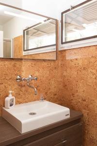 a bathroom with a white sink and a mirror at PART II apartman in Tiszaug +61 photos