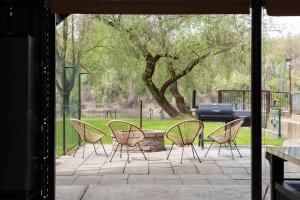 a group of chairs sitting on a patio at PART II apartman in Tiszaug