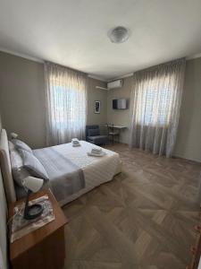 a bedroom with a bed and a table and a couch at B&B da Giusy in Chieti