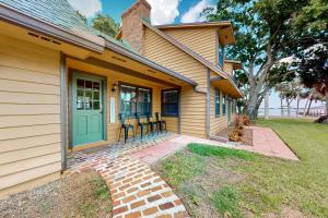 a house with a green door and chairs on the porch at 3424 Indian River Dr Main in Cocoa