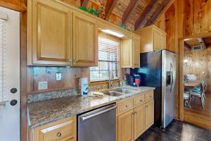 a kitchen with wooden cabinets and a stainless steel refrigerator at 3424 Indian River Dr Main in Cocoa