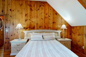 a bedroom with a large bed with wooden walls at 3424 Indian River Dr Main in Cocoa +32 photos