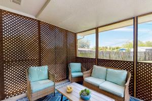 a porch with two chairs and a table at 2403 Auburn Dr in Cocoa