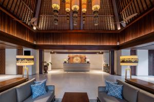 a lobby with couches and a large organ at Ramayana Suites and Resort in Kuta