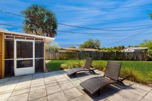 two chairs sitting on a patio in a yard at 2403 Auburn Dr in Cocoa