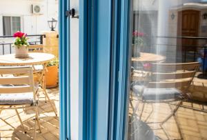 a sliding glass door with a table and chairs on a patio at Casa Mary Aegina in Egina