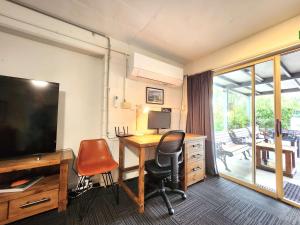 an office with a desk and a television and a chair at Spacious Guest Room 7 Sleeps 5 Near Shops with Free Parking in Highett +40 photos