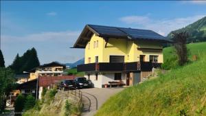 a house with solar panels on the roof at Walser Auszeit in Riezlern +24 photos