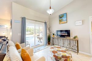 a living room with a couch and a tv at 620 S Easy St in Sebastian