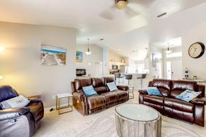a living room with leather furniture and a table at 620 S Easy St in Sebastian