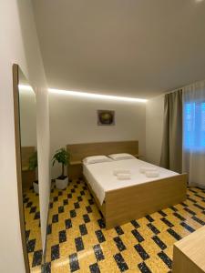 a bedroom with a bed and a potted plant at BORGO MARE 86 rooms in Porto SantʼElpidio
