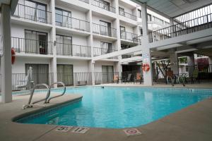 a large swimming pool in front of a building at Ramada by Wyndham Tulsa Broken Arrow in Broken Arrow