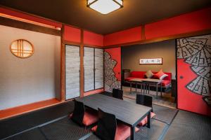a room with a table and chairs and a couch at Kamenoi Hotel Aso Park Resort in Aso