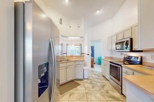 a large kitchen with a stainless steel refrigerator at 1295 Barber St in Sebastian +30 photos