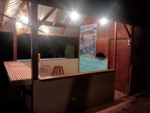 a small room with two stools and a sign on the wall at Pondok sunset inn in Senaru