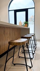 a row of tables in a bar with a window at Cliff Chalet-Amrat in Al Amarat