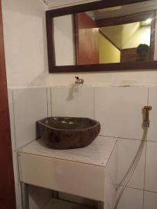 a sink in a bathroom with a mirror at Pondok sunset inn in Senaru