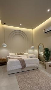 a bedroom with a large bed and a mirror at Cliff Chalet-Amrat in Al Amarat