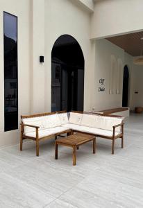 two wooden benches sitting in a room with at Cliff Chalet-Amrat in Al Amarat