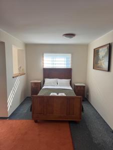 a bedroom with a bed and two night stands at Domek Trapera in Smyczyna