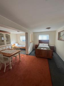 a bedroom with a bed and a table in it at Domek Trapera in Smyczyna
