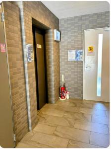 a hallway with a door and a tile wall at The Peak Tengachaya 605 KIX Direct Cozy Elegance near Namba in Osaka +38 photos